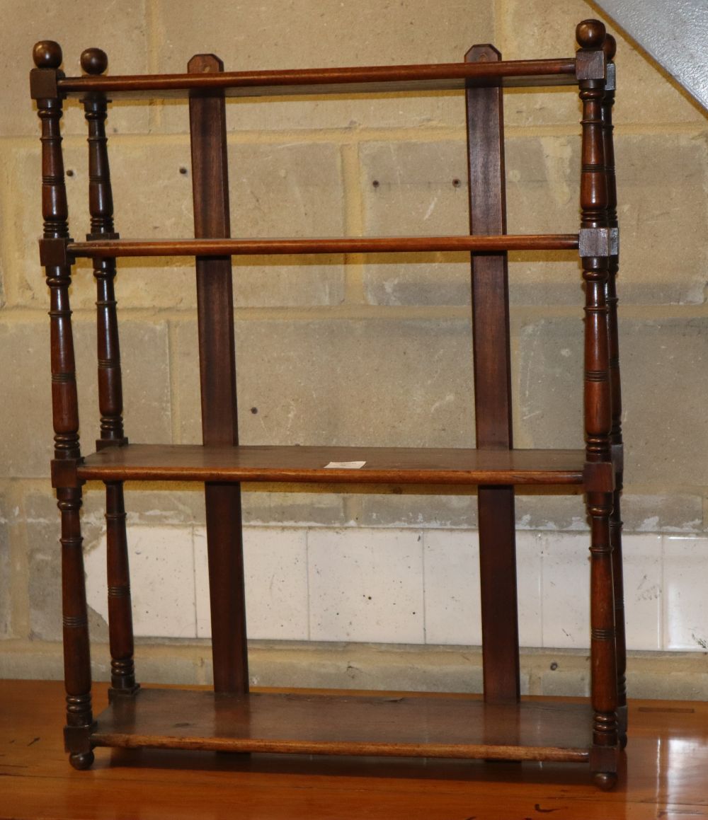 A Victorian mahogany three tier wall shelf with round finials, W.62cm, D.18cm, H.80cm